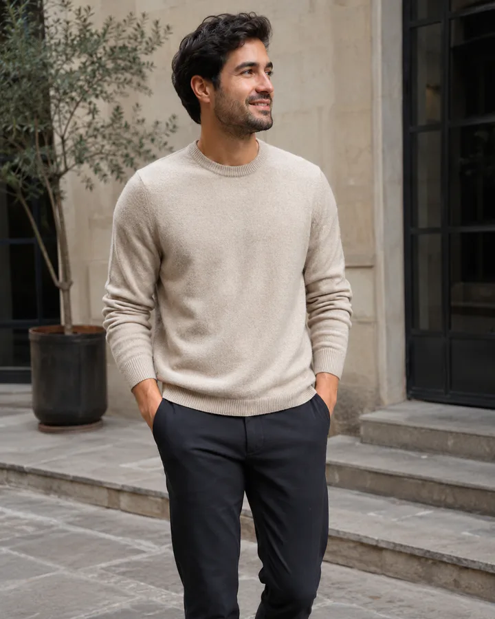 Customer wearing a beige sweater in a sunlit courtyard
